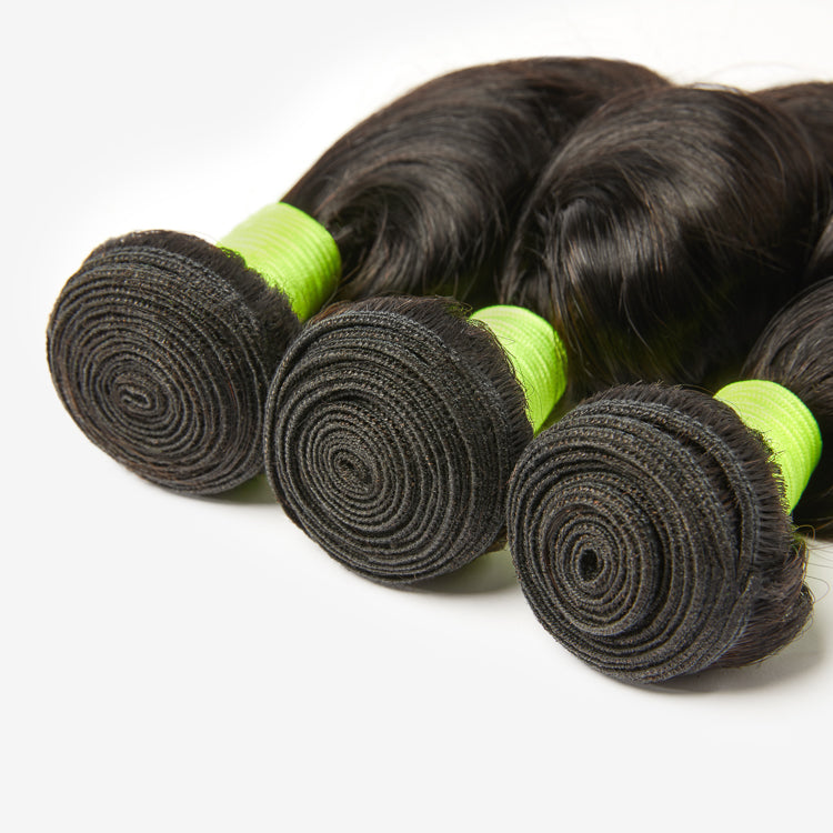 Three loose wave 100% virgin human hair bundles from Luvme, showcasing soft, natural-looking hair with a gentle wave pattern.
