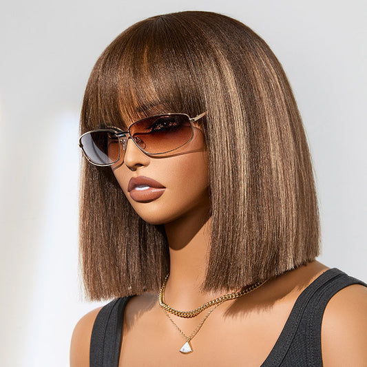 Ash blonde highlights with dark brown base Yaki blunt cut bob wig featuring bangs, minimal lace, short and glueless by Luvme Hair.